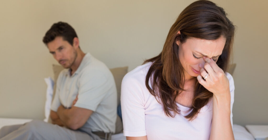 Unhappy couple not talking after an argument in bed at home