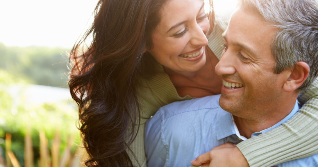 Loving Hispanic Couple In Countryside
