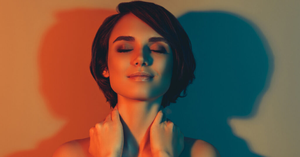 Photo of inspired cute tender bob hairstyle woman close eyes touch neck isolated red neon light color background