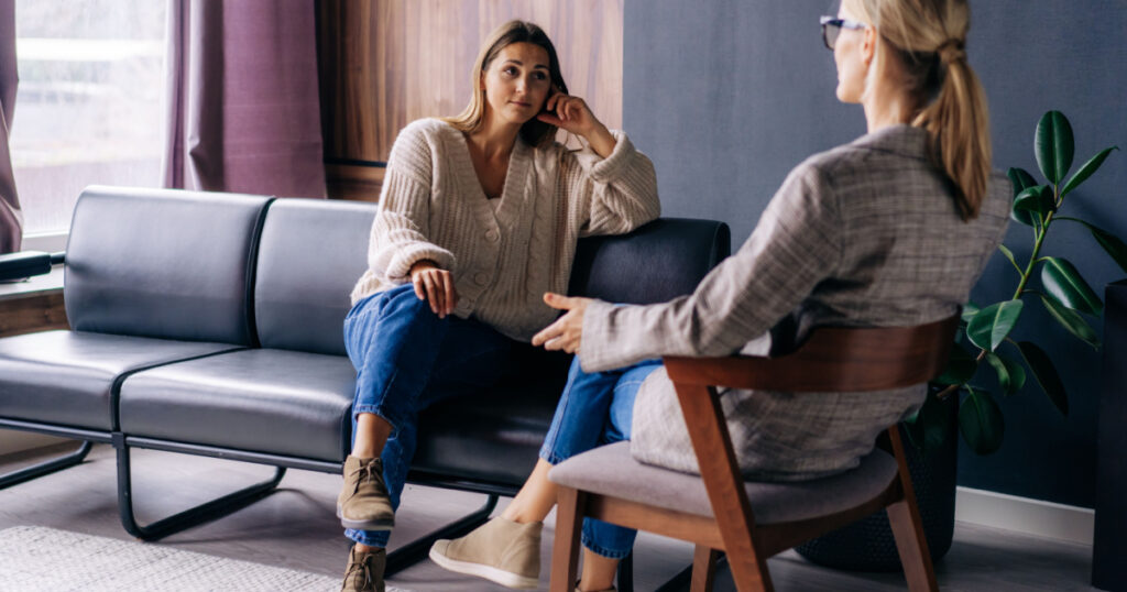 A young woman in a consultation with a professional psychologist listens to advice on improving behavior in life. The modern millennial woman is developing mindfulness and psychological health.