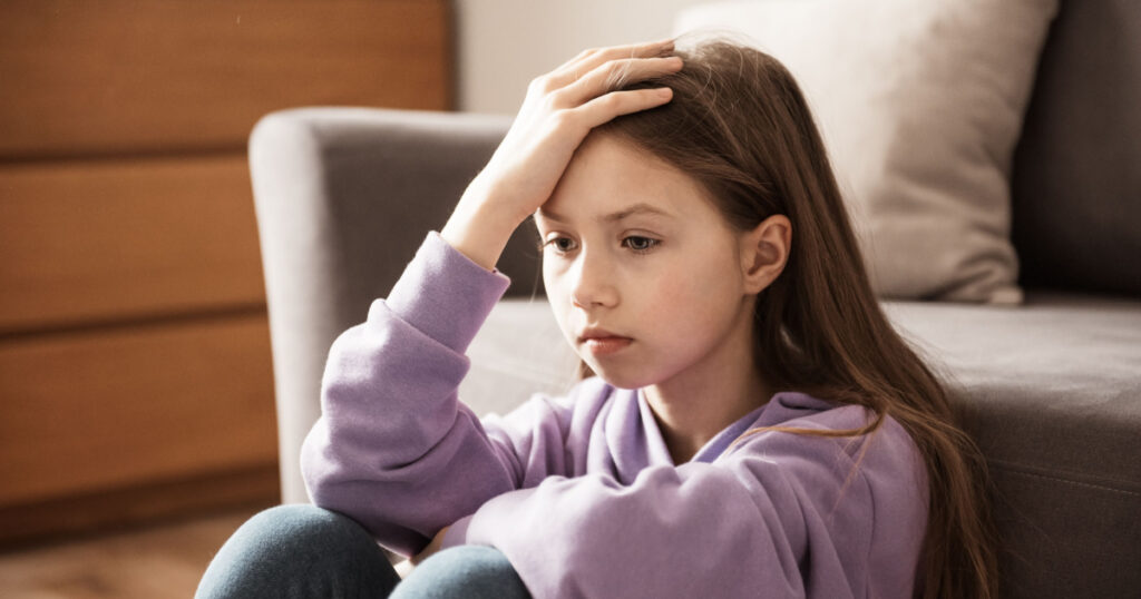 Sad child at home. Abuse. Depression girl indoors. Family problems, misunderstanding of parents, parenting mistakes, domestic violence