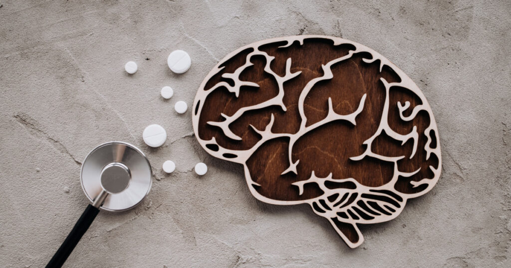 A stethoscope and brain with pills. Awareness of Alzheimer's, Parkinson's disease, dementia, stroke, seizure or mental health.