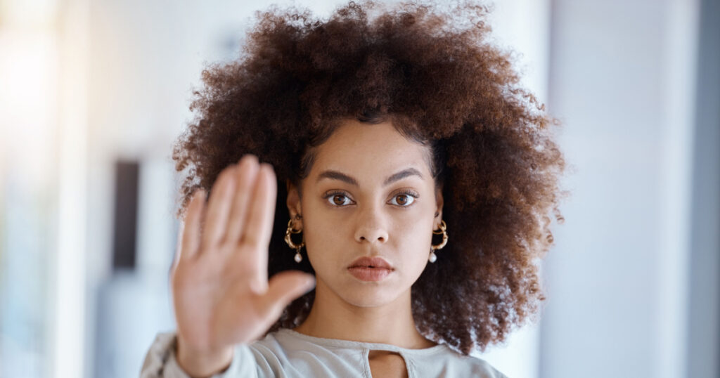 Hands, hr and manager stop sign with hand in office, serious, power and change in corporate. Black woman fighting sexual harassment, discrimination and toxic work environment with employee protection