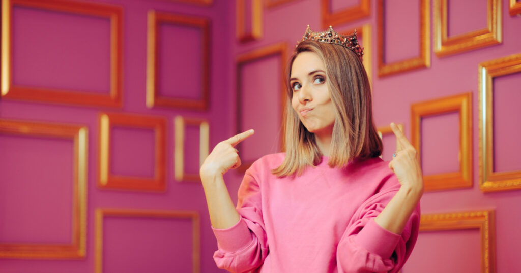 Vain Queen Wearing a Crown Pointing to Herself. Attention seeker diva behaving princess girl feeling self-important and overconfident