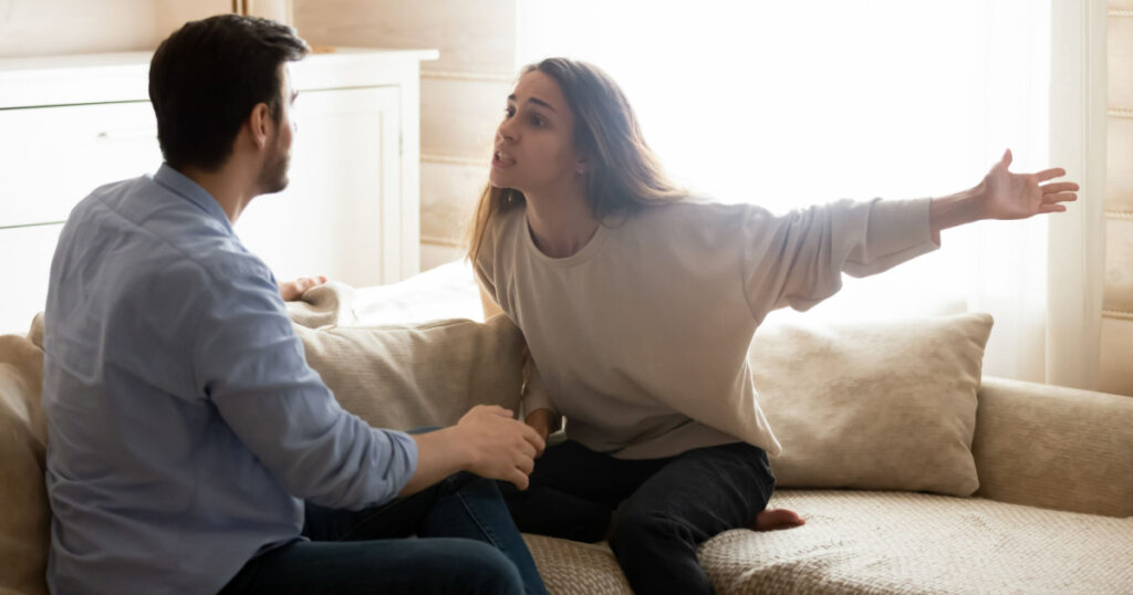 Misunderstanding. Angry worried young spouses quarreling arguing at home, annoyed nervous millennial wife shouting screaming on frustrated husband accusing in cheat threatening with breakup divorce
