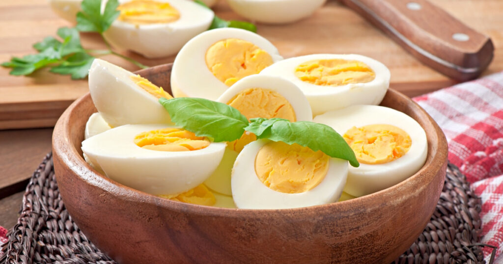 Boiled eggs in a bowl decorated with parsley leaves