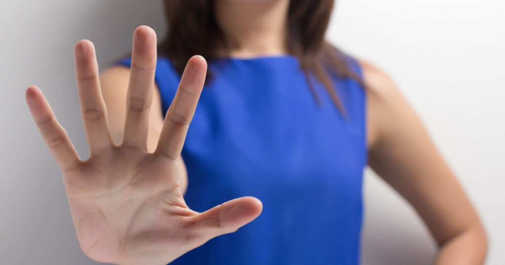 young woman showing her denial with NO on her hand