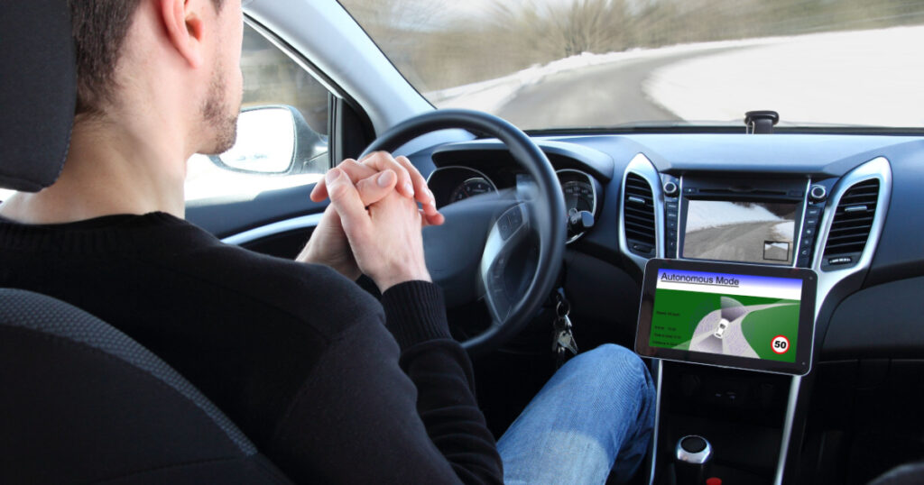 A man in a Autonomous driving test vehicle