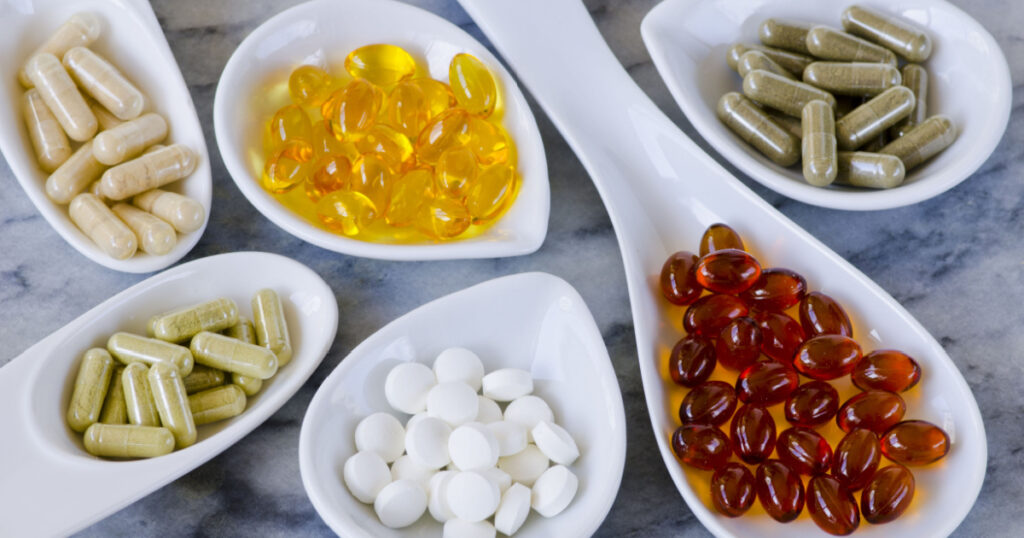 Variety of dietary supplements, including capsules of Garlic, Evening Primrose Oil; Artichoke Leaf; Olive Leaf; Magnesium and Omega 3 Fish Oil.Selective focus. Taken in daylight.