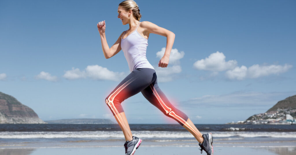 Digital composite of Highlighted leg bones of jogging woman on beach