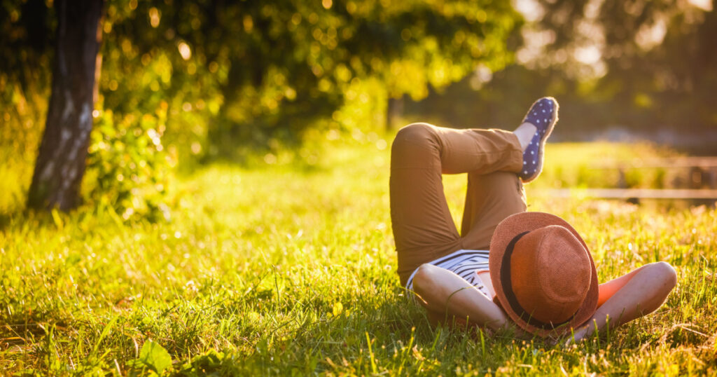 Trendy Hipster Girl Relaxing on the Grass