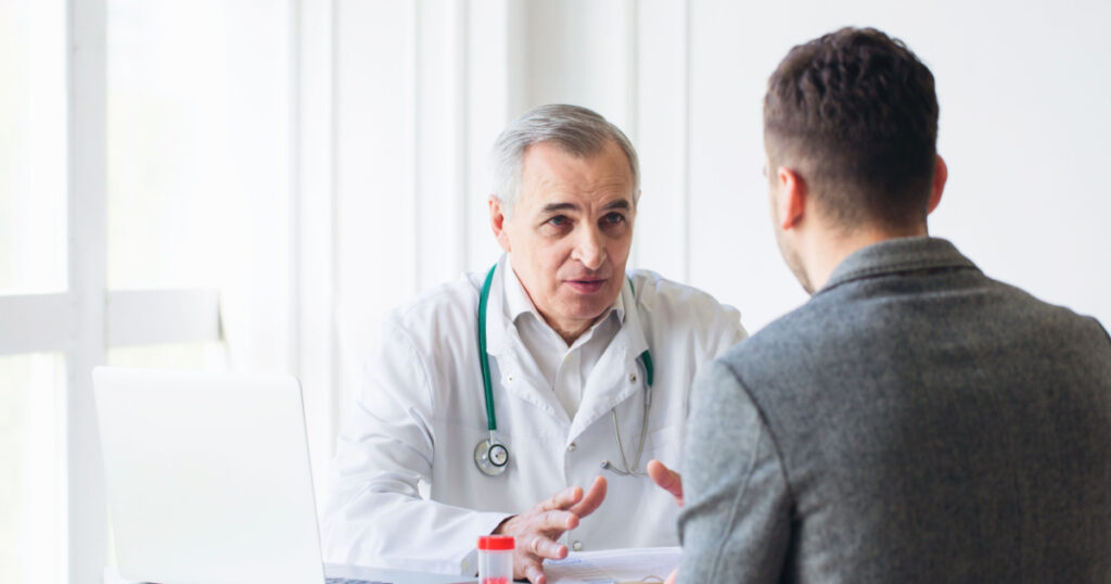 Senior doctor consults young patient