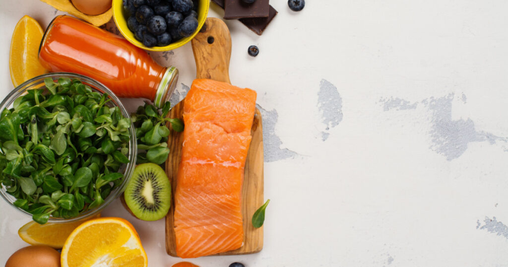 Healthy food good for eyes over white table. Products for excellent vision. Space for text
