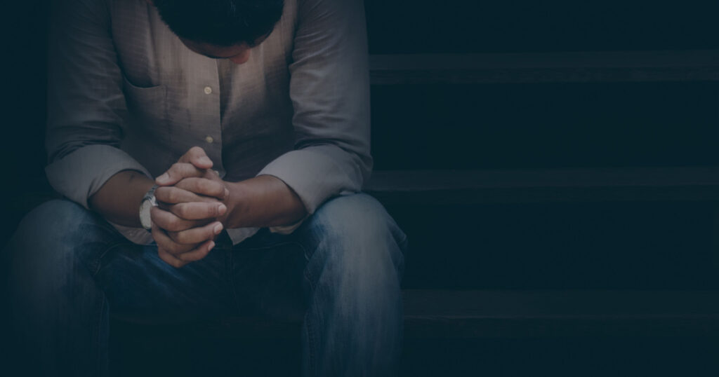 A man are sad and stressed in black background