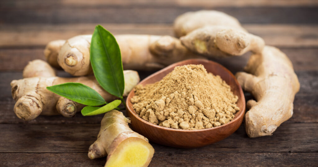Ginger root and ginger powder in the bowl