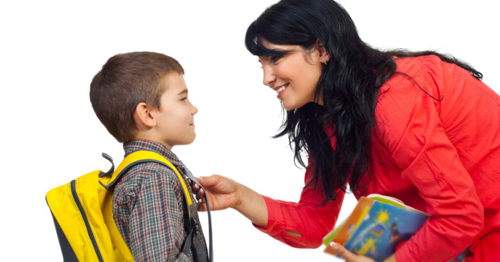 Mother having an conversation with her son before going to school and standing face to face isolated on white background
