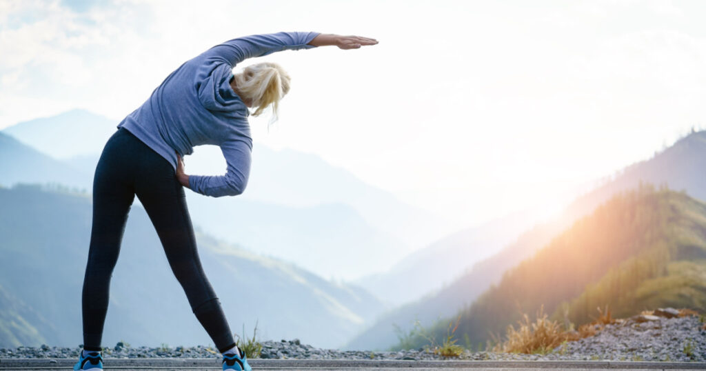 Athlete at the top of the mountain doing workout