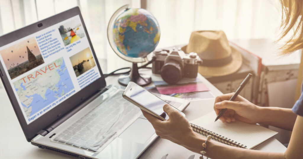 Young woman planning vacation trip and searching information or booking an hotel on a smart phone and laptop, Travel plan concept