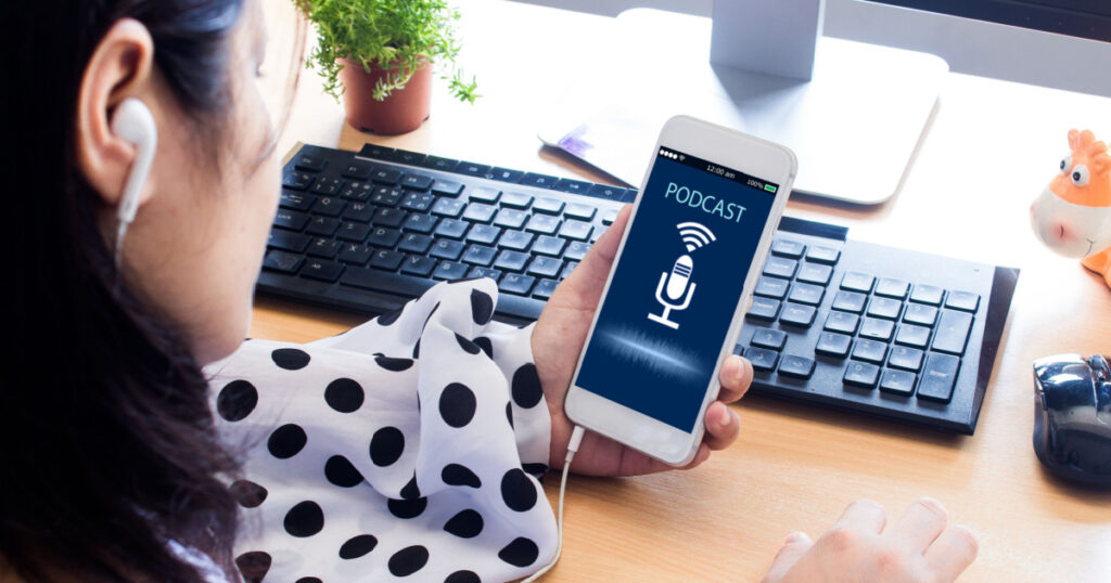 Podcast concept.Female hands holding mobile phone and listening podcast