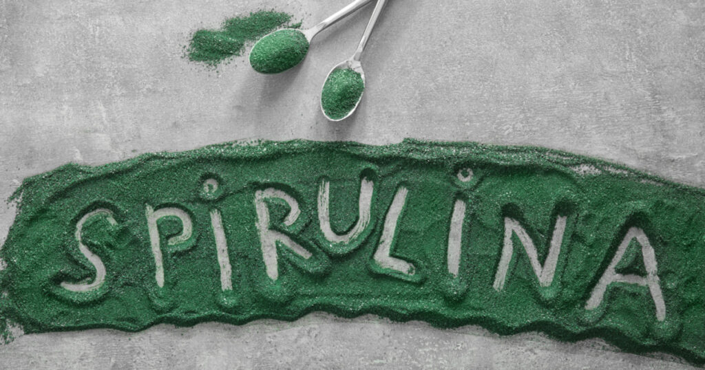 Word SPIRULINA written on powder