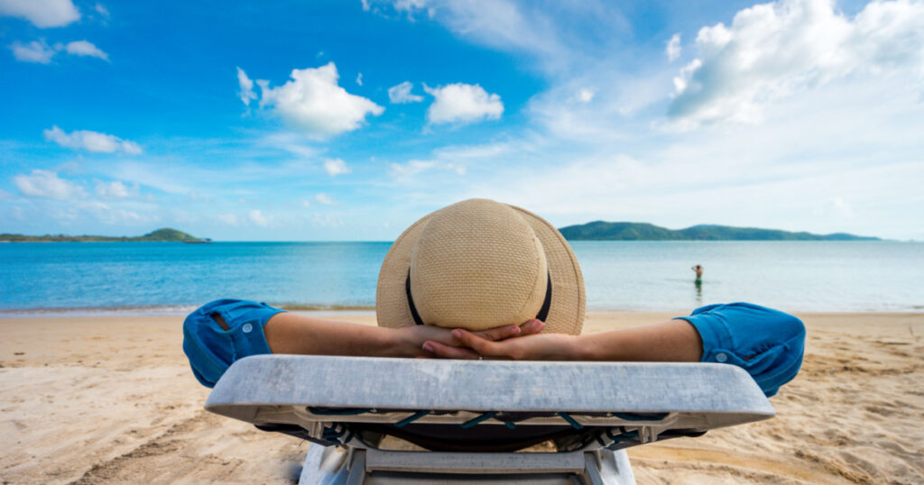 Young woman relaxing on beach, ocean view, Vacation Outdoors Seascape Concept