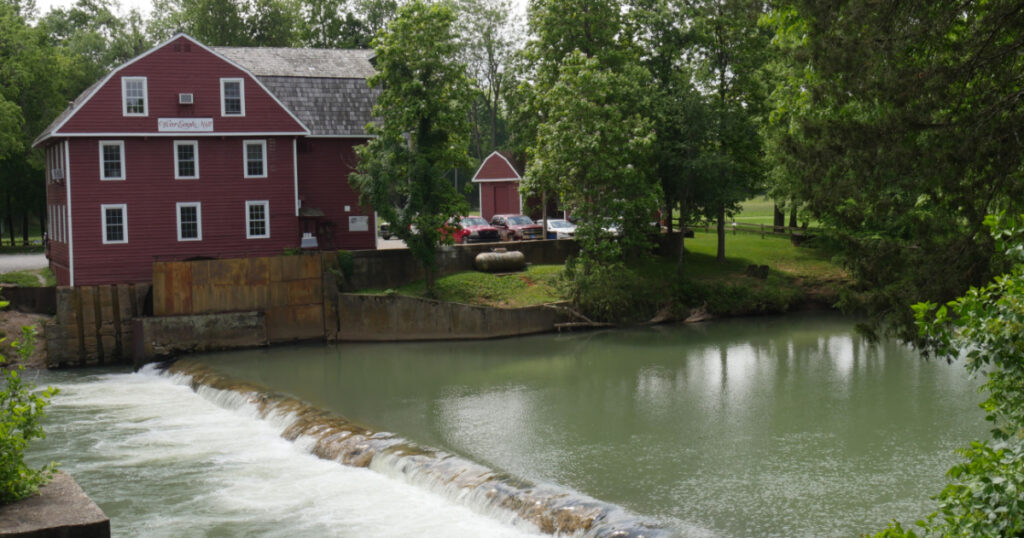 ROGERS, ARKANSAS—MAY 2017: Historic War Eagle Mill building viewed from across the river in Rogers, Arkansas.