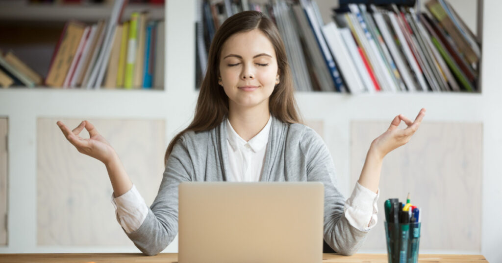 Calm woman relaxing meditating with laptop, no stress free relief at work concept, mindful peaceful young businesswoman or student practicing breathing yoga exercises at workplace, office meditation