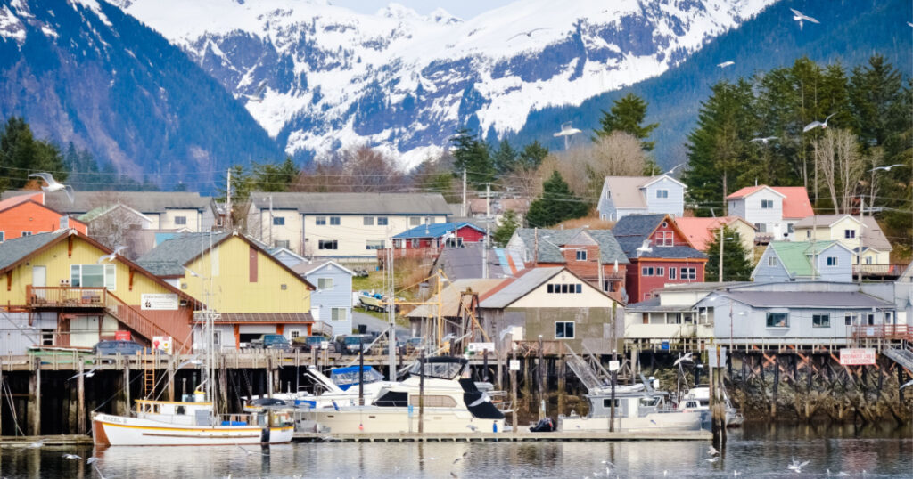 Sitka, Alaska / USA - April 22, 2013: View Of Sitka Alaska Boats and Buildings from the Water with Mountain Background