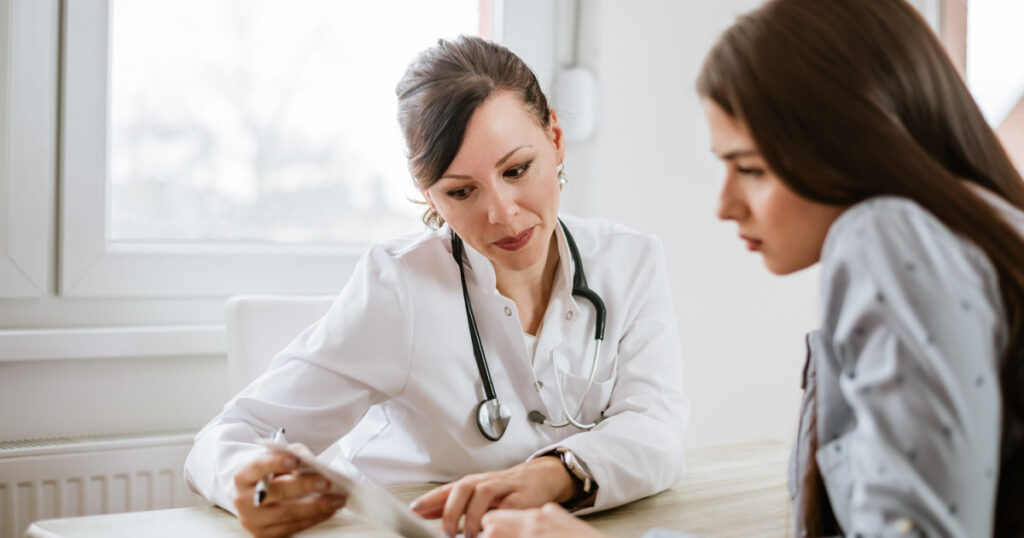 Charming female doctor giving advice to a female patient.