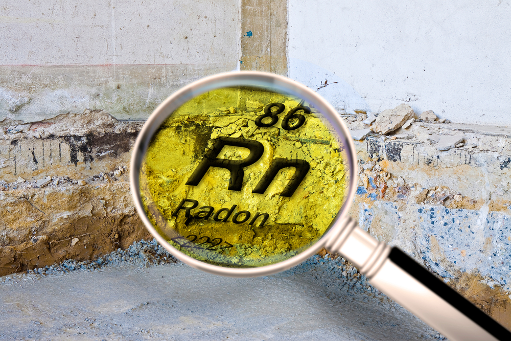 Preparatory stage for the construction of a ventilated crawl space in an old brick building - Searching gas radon concept image seen through a magnifying glass.
