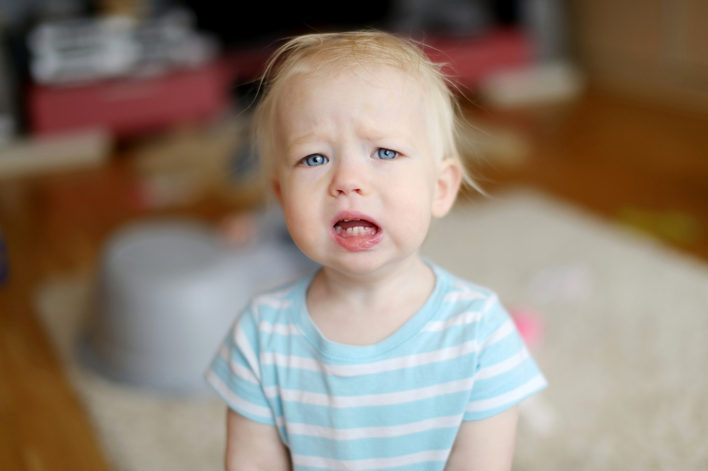 Angry upset toddler girl at home