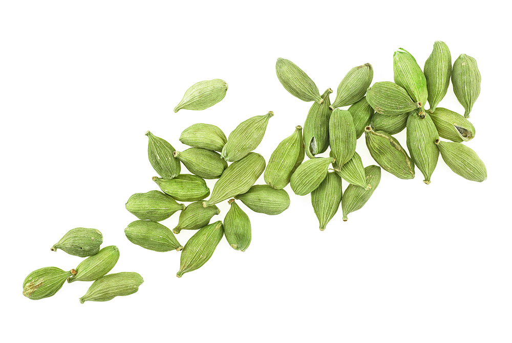 Green cardamom seeds isolated on a white background, top view. Cardamom pods.
