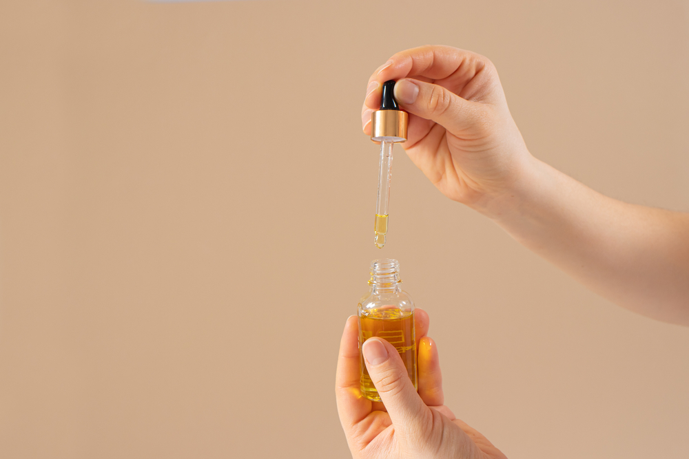 Castor oil for eyelashes and eyebrows for hair growth in a glass jar with a dropper