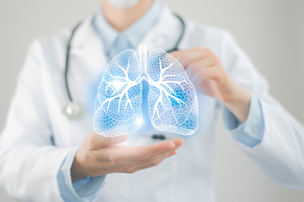 Female doctor holding virtual Lungs in hand. Handrawn human organ, copy space on right side, raw photo colors. Healthcare hospital service concept stock photo
