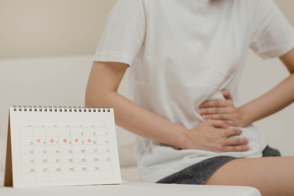 Menstruation, period cycle day of monthly, hurt asian young woman, female hand in stomachache, suffer from PMS premenstrual, belly or abdomen pain on bed at home. Health problem Inflammation in body