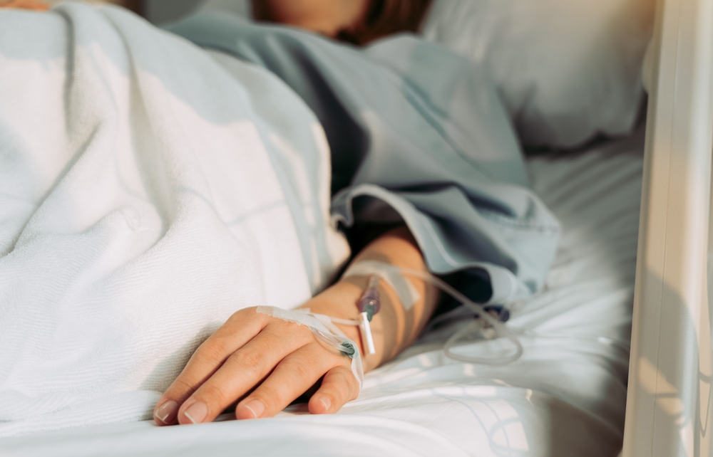 Asian woman lying sick in hospital.
