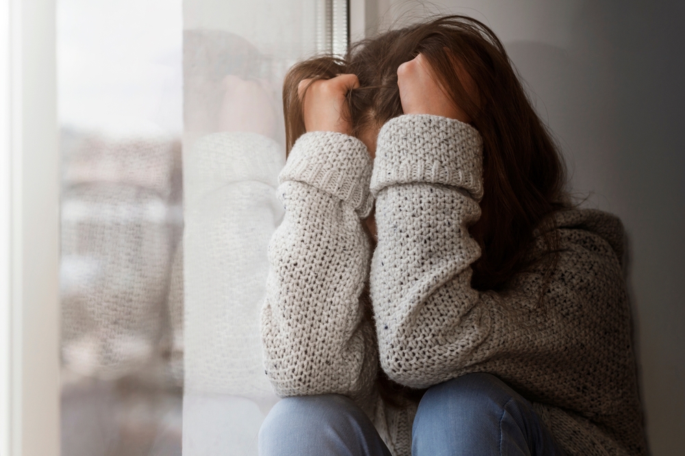 Unhappy Stressed Teen suffering Alone by Window. Depressed Teenage need Help and Support. Difficult Problems of Teenager.
