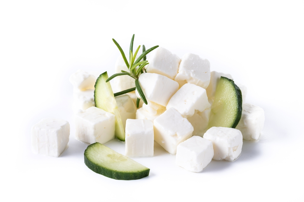 Feta cheese, cucumber and herbs isolated on white bckground
