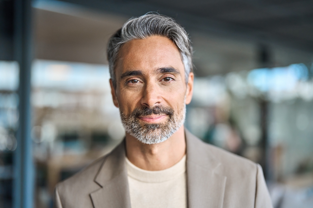 Close up headshot portrait of happy middle aged older professional business man, smiling bearded mature executive ceo manager, older male entrepreneur, rich confident business owner in office.
