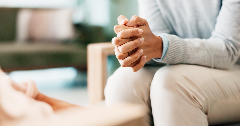 Psychology, mental health or woman hands with psychologist in consultation office for mind, assessment or evaluation. Help, anxiety or counseling for nervous patient with stress at clinic for therapy
