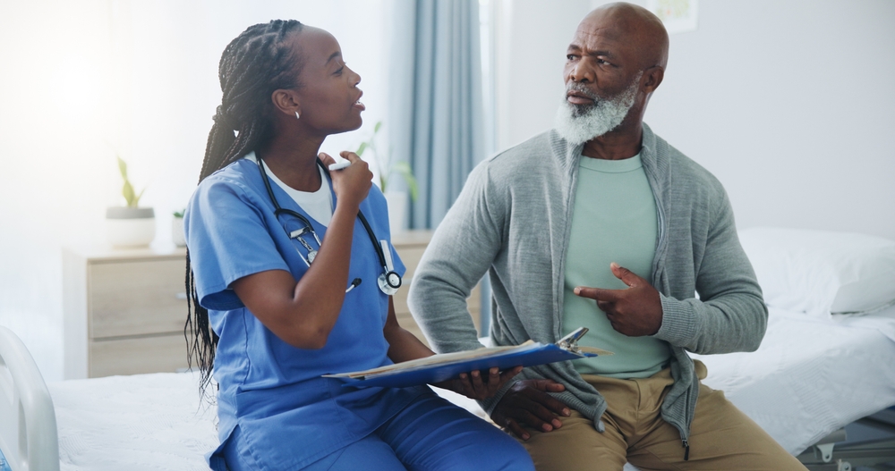 Consultation, senior man and nurse with clipboard, healthcare and questions for medical info. Black people, elderly patient and caregiver for arthritis, alzheimer and talking with checklist on bed