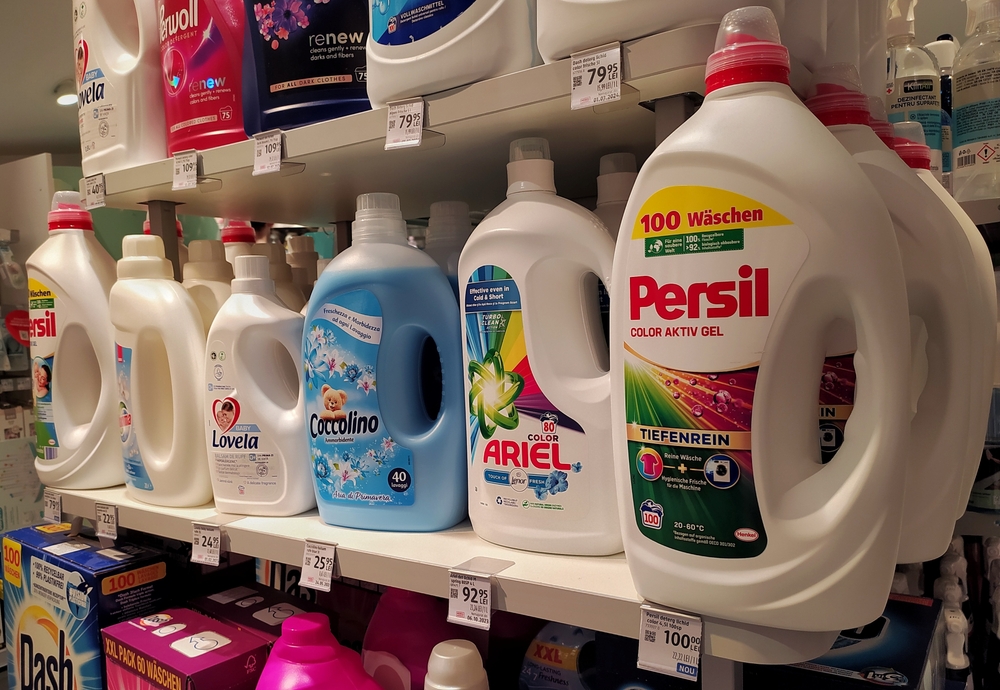 Liquid laundry detergent on the shelf in the store for sale. Liquid laundry detergent of different brands displayed in the supermarket. Department of household chemicals. Arad, Romania, July 30, 2024
