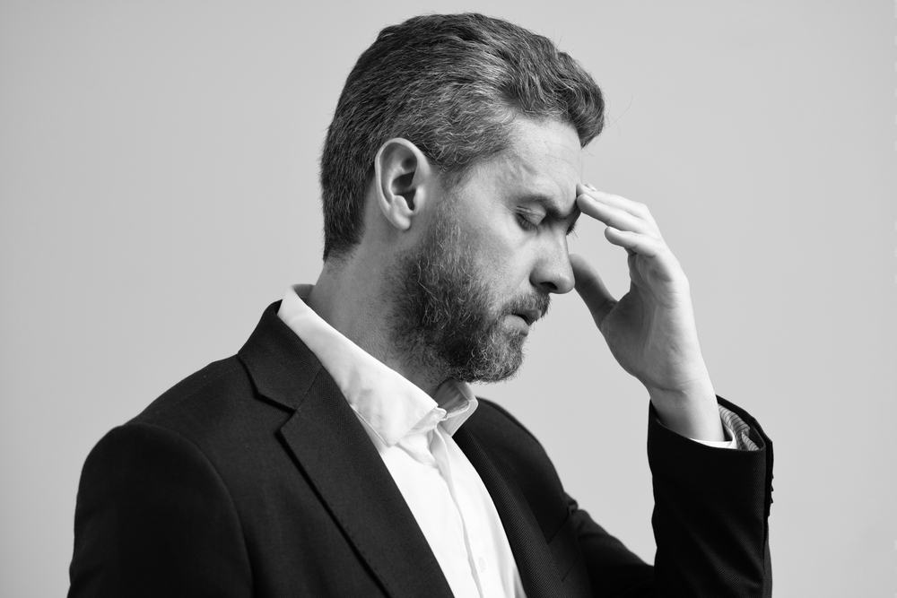 Overworked man feeling migraine head strain. Stressed, tired man with headache. Stress and headache. Businessman feel stressed. Stressful businessman. Overworked man business manager. Job Strain