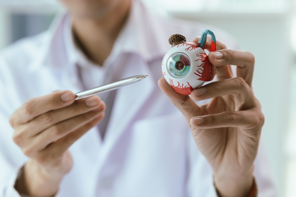 An elderly Asian woman visits an ophthalmologist at a clinic for an eye exam, addressing conditions like cataracts, glaucoma, and presbyopia, with advanced diagnostic tools for vision health.