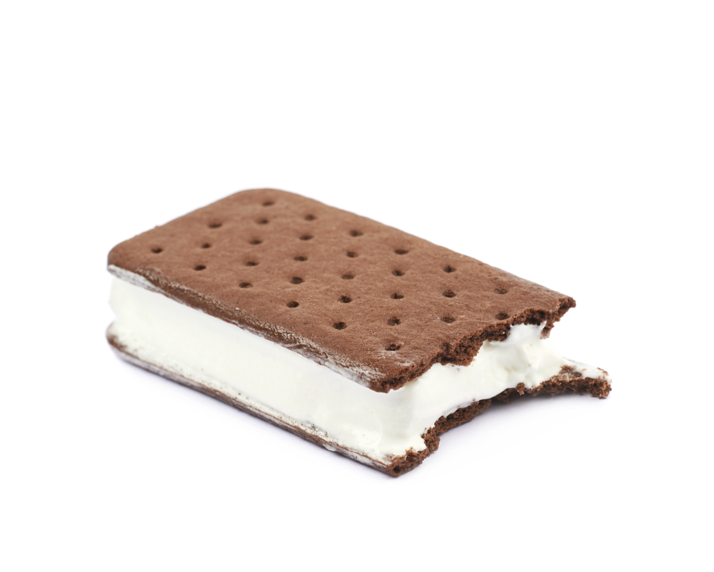 Chocolate vanilla ice cream sandwich with a bite taken off it, composition isolated over the white background
