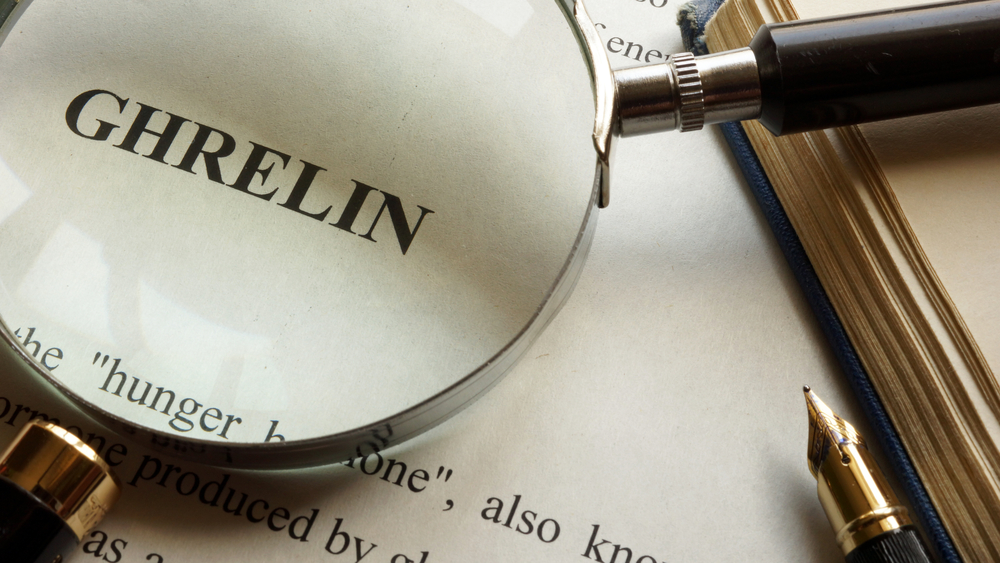 Paper with word Ghrelin and a book.
