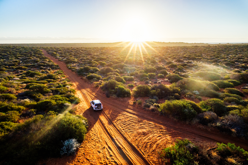 Australia, red sand unpaved road and 4x4 at sunset, Francoise Peron, Shark Bay

