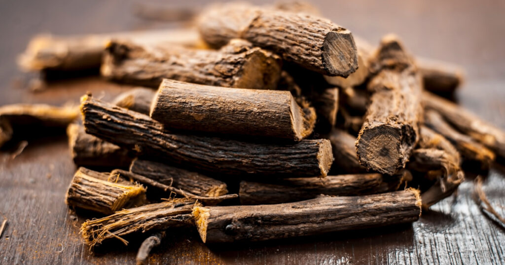 Close up of Ayurvedic herb Liquorice root,Licorice root, Mulethi or Glycyrrhiza glabra root on a wooden surface is very much beneficial for Soothes your stomach,poisoning, stomach ulcers, etc.