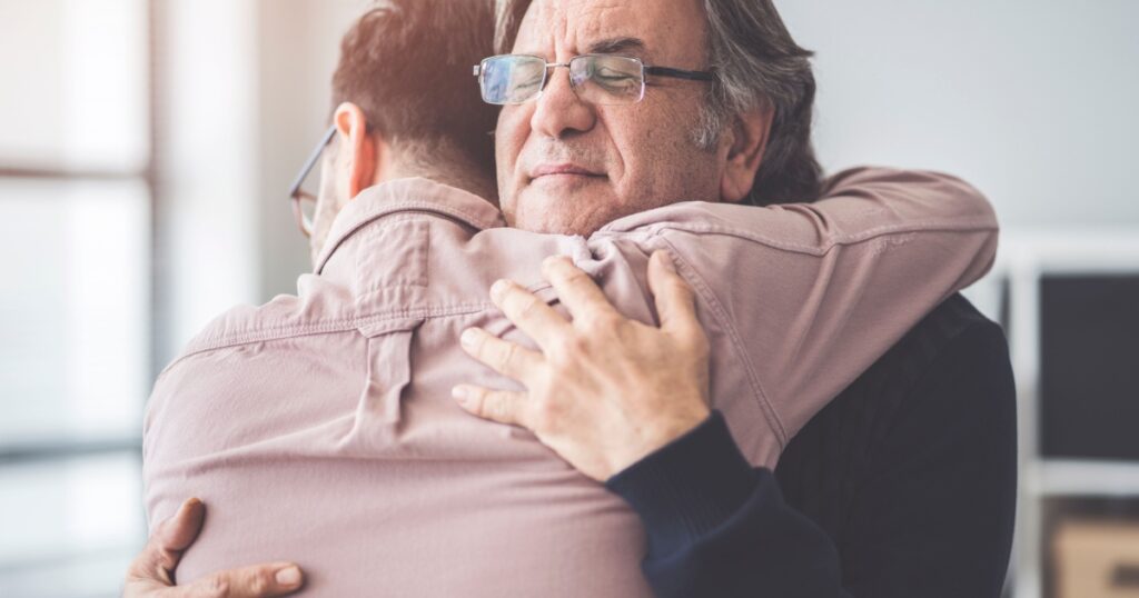 Son hugs his own father
