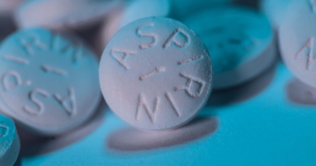 White Aspirin macro shot on aqua blue background